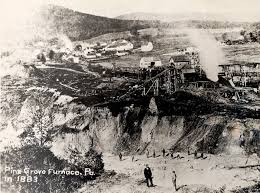 A photo of the Pine Grove Iron Furnace operating in 1883 showing the extensive quarrying and deforestation of the surrounding area.