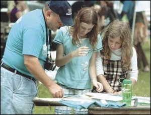 Paul Garrett, left, talks about the Mechanicsburg Area Environmental Club with Hope Schap and Julia Locy, both 11. They were taking part in the “Green Festival” at LeTort Park in Carlisle on Saturday. (Jason Malmont/The Sentinel)