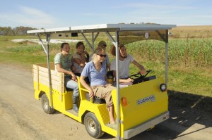 Student workers zip around the farm on our Solar Wheeler, a solar-powered golf cart.