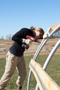 Claire Fox '11 helps construct one of the farm's greenhouses.