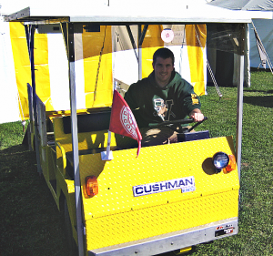 Sam Wheeler and the solar-powered Cushman golf cart he built with Matt Steiman for an independent research project.