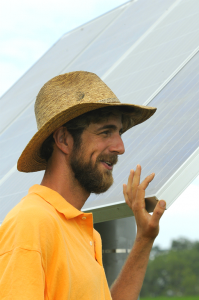 Matt Steiman talks with group tour members about one of the farm's solar panels.