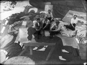 Pable Picasso (wearing a berat) pictured with scene painters for Parade. Curtesy of wikicommons.