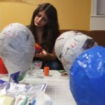 student participate in special day of the dead piñata making