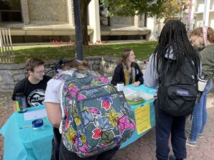 Image shows students engaging with the Sustainability Day table 