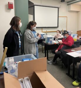 Two student watershed coordinators explain how to safely store and use equipment.