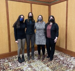 Photo shows all four presenters stand together for a group photo