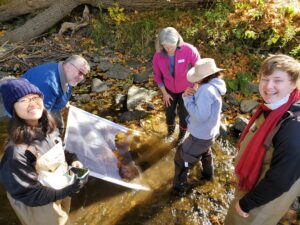 One group works on the kick protocol to collect macroinvertebrates