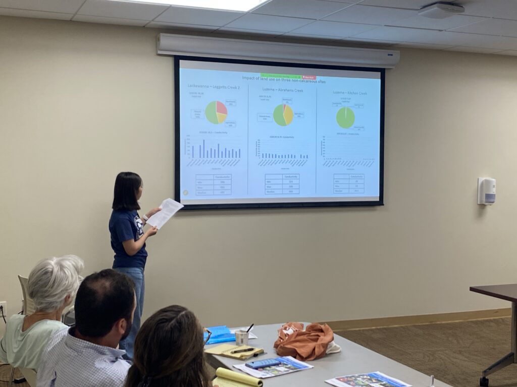 Ayako walks through graphs during the informational presentation