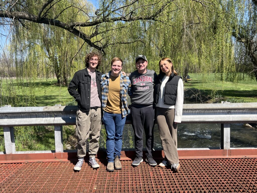 Crosby, David, Max, and Marja pose for a photo on a bridge overlooking the Letort.