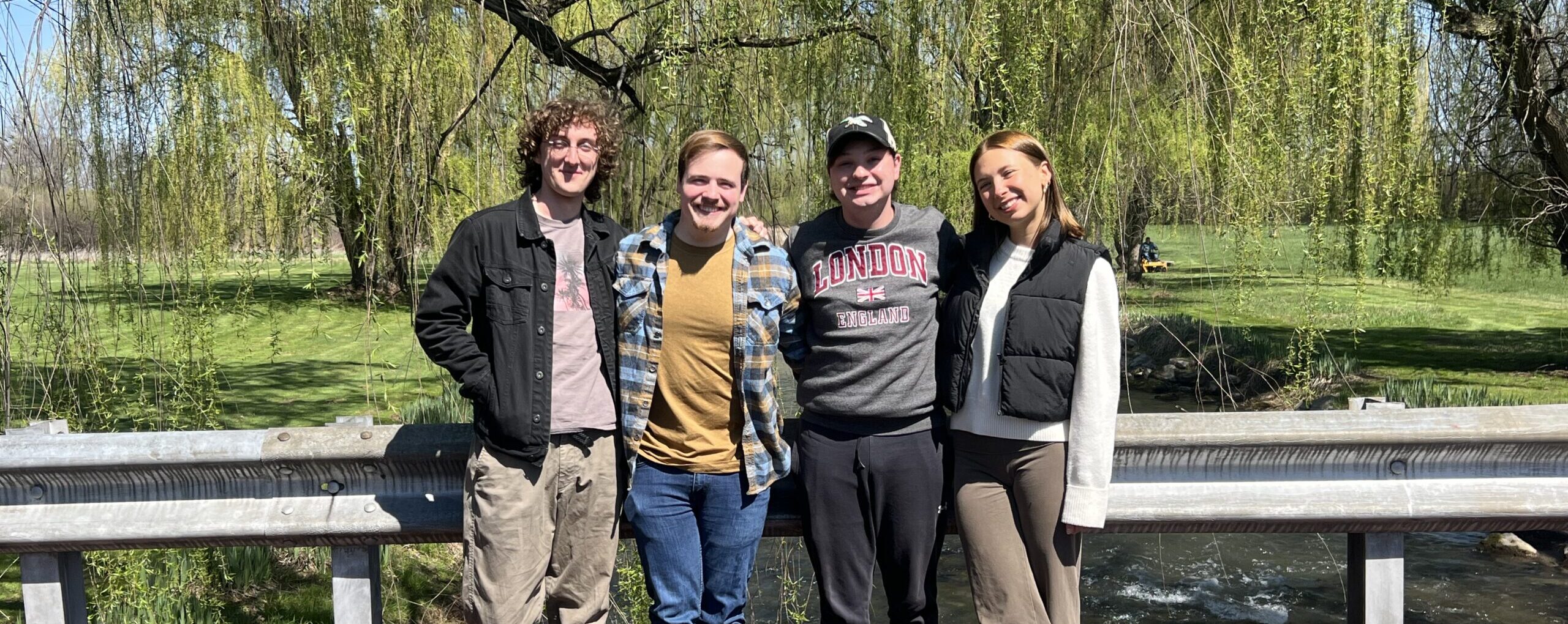 Crosby, David, Max, and Marja pose for a photo on a bridge overlooking the Letort.