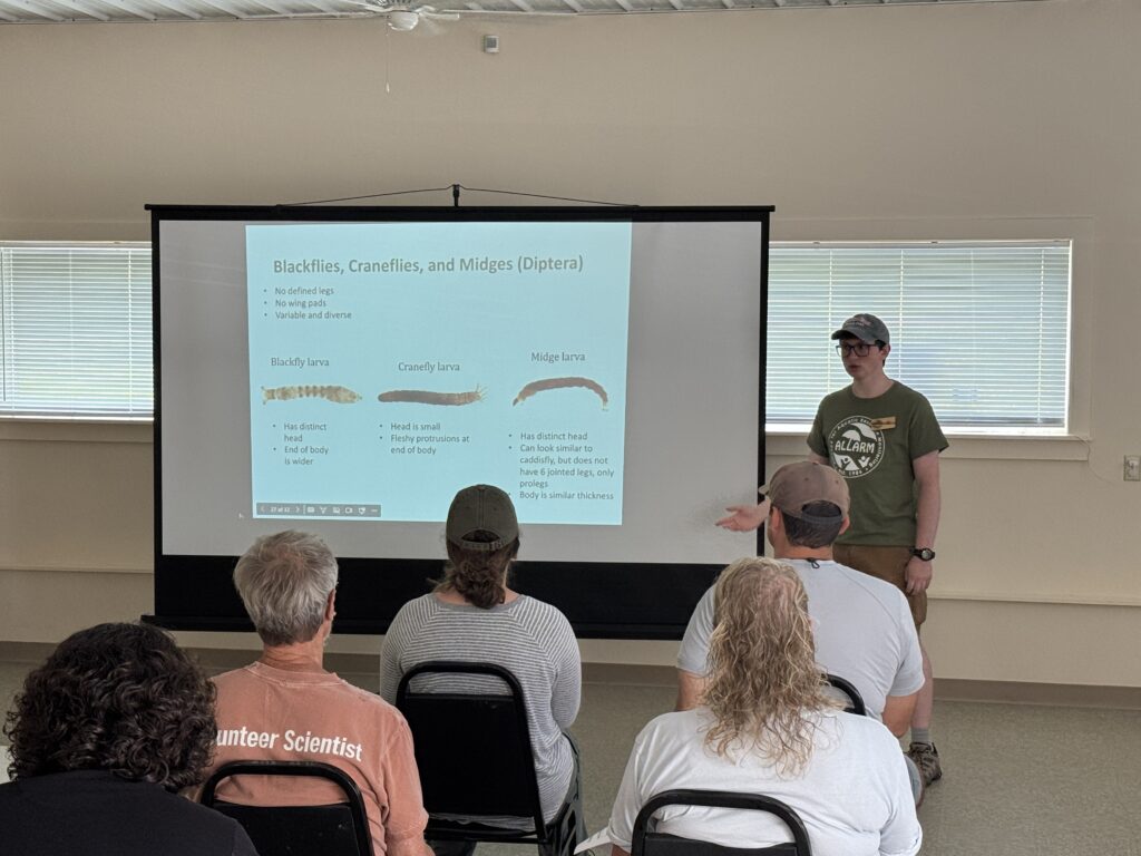 Ryan presenting a slide about macroinvertebrate identification to members of OCCA.