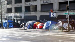 Tents line the street of Seattle next to a parking garage