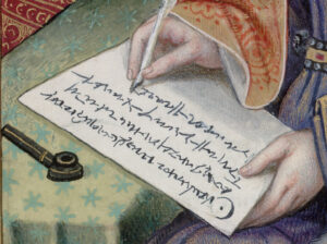 woman's hand writing a letter