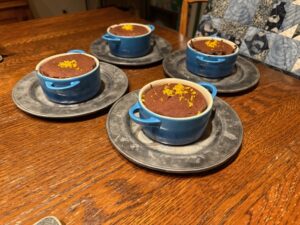 Photo of chocolate lava cakes, topped with grated orange peel. 