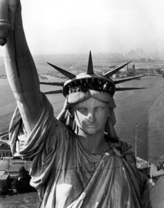 An image depicting a close up of the Statue of Liberty's upper half