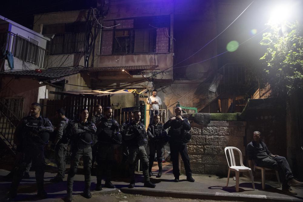 Israeli police stand guard in front of a Palestinian home occupied by settlers during a protest on the eve of a court verdict that may forcibly evict Palestinian families from their homes in the Sheikh Jarrah neighborhood of Jerusalem, Wednesday, May 5, 2021. Several Palestinian families in Sheikh Jarrah have been embroiled in a long-running legal battle with Israeli settler groups trying to acquire property in the neighborhood near Jerusalem's famed Old City. (AP Photo/Maya Alleruzzo)