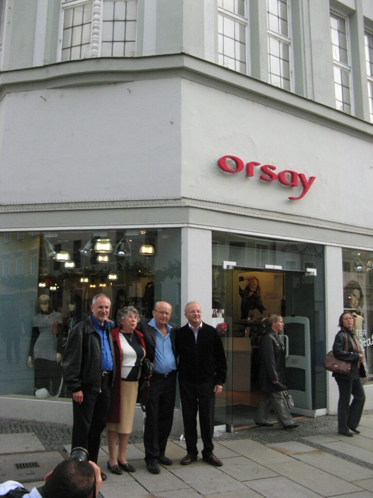 Four people in front of a store
