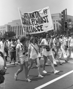 People walking in the street holding sign saying "atlanta lesbian-feminist alliance