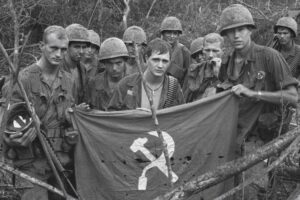 Soldiers with a captured enemy flag in 1967 (Getty Images)