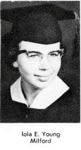 A black and white portrait photo of 20-year-old Iola, wearing a graduation cap and cat's eye-style glasses.