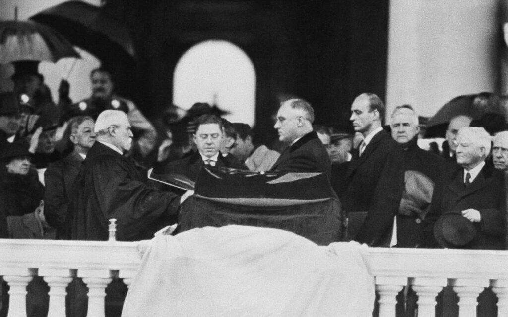 Photograph of Chief Justice Charles Evans Hughes swearing in President Franklin Delano Roosevelt after winning his second presidential election.